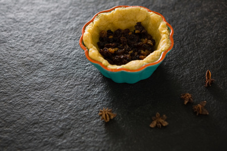 Close-up of raisin being stuffed while preparing tartの写真素材