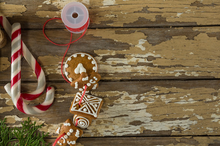 Close-up of sweet food and christmas decorations on wooden plank