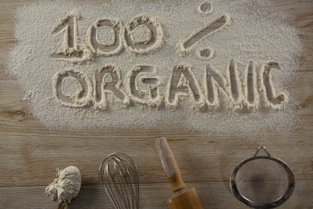 Over head view of the word 100 percent organic written on sprinkled flourの写真素材