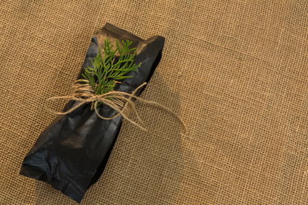 Overhead of christmas gift wrapped with jute rope during christmas timeの写真素材