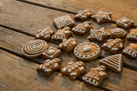 High angle view of various ginger bread cookies on wooden table