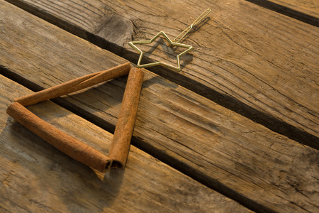 Close up of cinnamon stick with star shape on wooden tableの写真素材