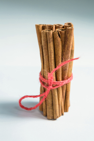 Bunch of cinnamon sticks on white table