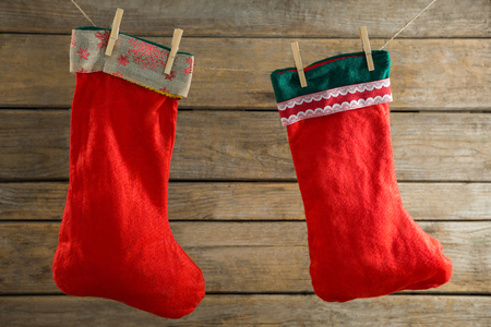 Close up of stockings hanging on rope against wooden wallの写真素材