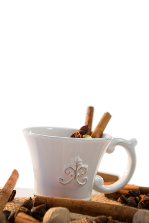 Close-up of spice tea with various ingredients against white backgroundの写真素材