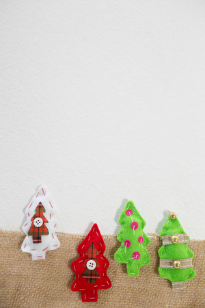 Close-up of various handmade christmas tree on white backgroundの写真素材