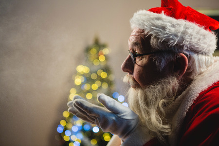 Santa Claus blowing kiss at homeの写真素材