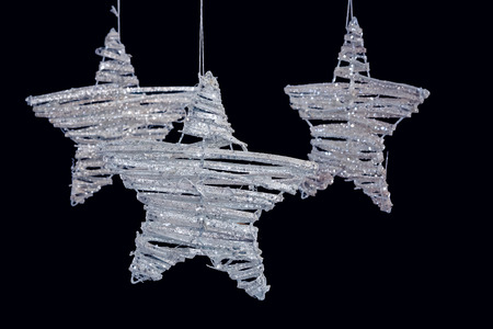Close-up of handmade stars hanging against black background