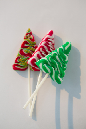 Various christmas tree lollipops on white backgroundの写真素材
