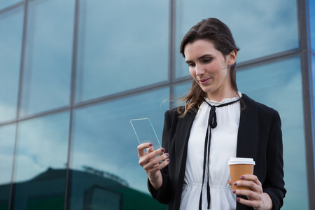 Female executive using glass sheet in office premisesの写真素材
