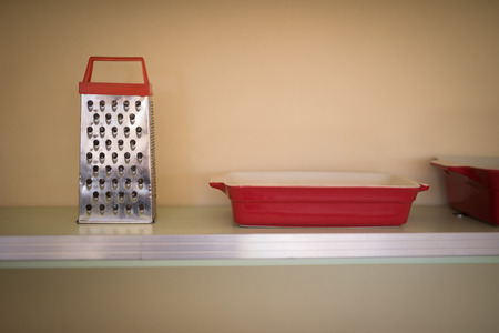 Grater and tray in the shelf at restaurant