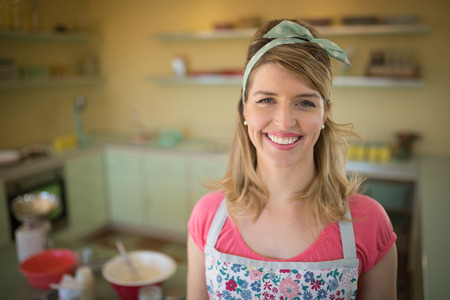 Portrait of waitress standing in restaurantの写真素材