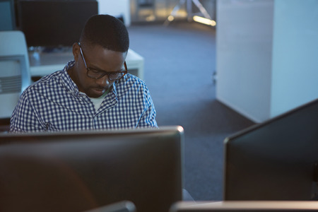Computer engineer working at desk in officeの写真素材