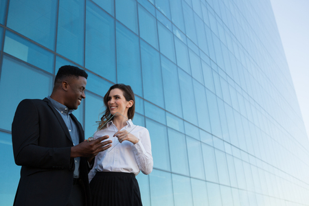 Male and female executive using glass digital tablet in office premisesの写真素材