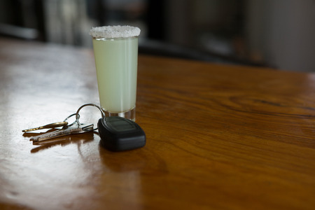 Close-up of tequila shot glass and car keysの写真素材