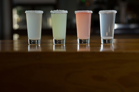 Close-up of tequila shot glasses in barの写真素材