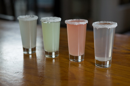 Close-up of tequila shot glasses in barの写真素材