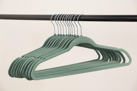Close-up of hangers arranged on clothes rackの写真素材