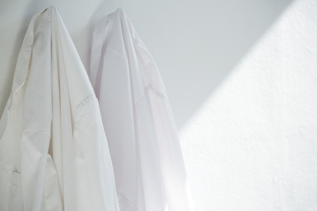 Close-up of shirts hanging on wallの写真素材