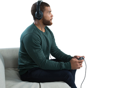 Side view of man playing video game against white background