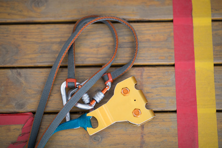 Close-up of carabiner with wire rope on wooden