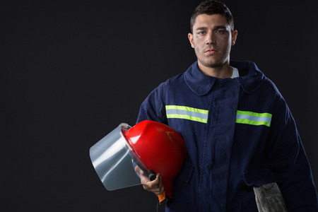 Portrait of fireman holding a safety helmet