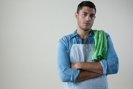 Confident waiter standing with his hands crossedの写真素材