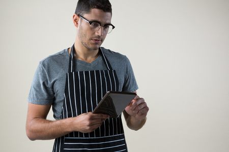 Close-up of waiter looking at the digital tabletの写真素材