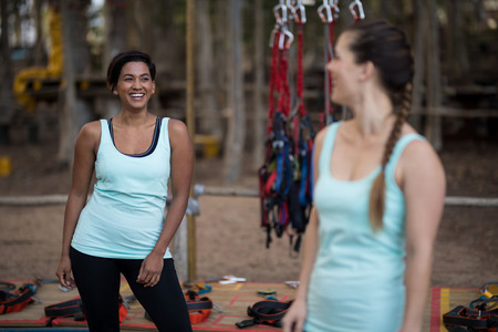 Happy friends interacting with each other in forest