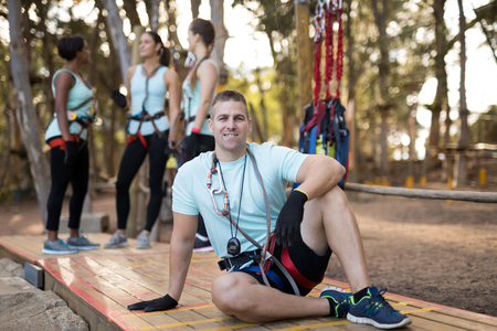 Portrait of confident man relaxing on wooden plankの写真素材