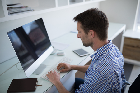 Man working on person computer at deskの写真素材