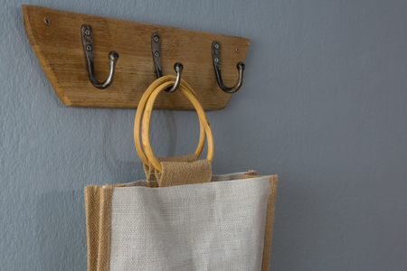 Close-up of handbag hanging on hookの写真素材