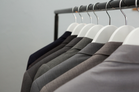 Close-up of blazers hanging on cloth hangerの写真素材