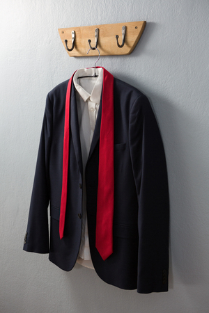 Close-up of blazer hanging on hookの写真素材