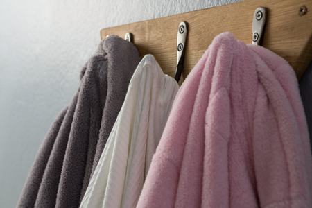 Close-up of bathrobes hanging on hook