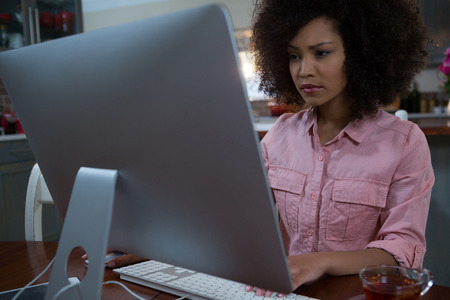 Young woman using computer at home