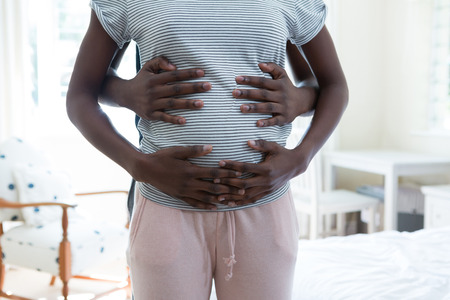 Mid section of man and woman feeling the presence of babyの写真素材