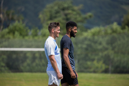 Two football players standing in the ground on a sunny dayの写真素材
