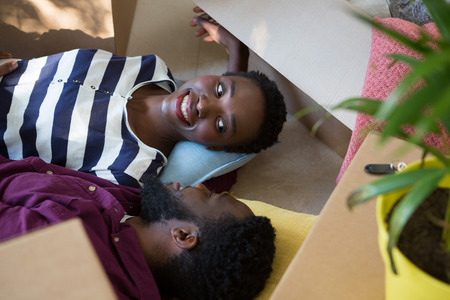 Happy couple relaxing in new houseの写真素材