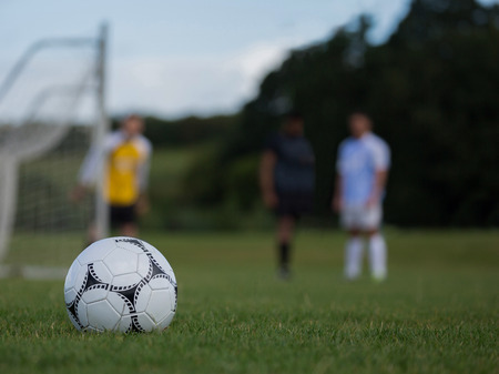 Close-up of soccer ball on green grassの写真素材
