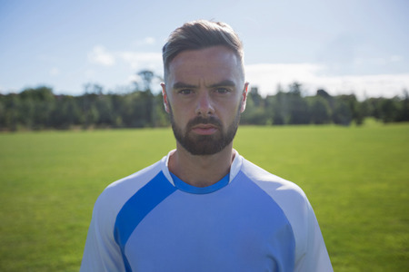 Portrait of football player standing in the groundの写真素材