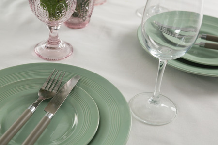 Close-up of plate and cutlery set elegantly on a tableの写真素材