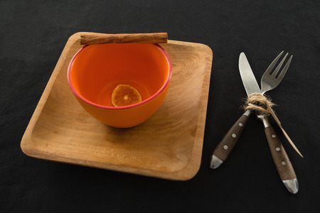 Plate and cutlery set on a table with lemon in bowlの写真素材
