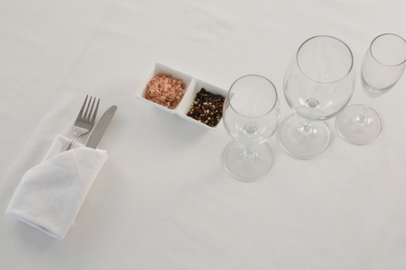 Fork, butter knife and spoon in napkin on white backgroundの写真素材
