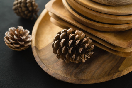 Close-up of wooden plates set on a black theme tableの写真素材