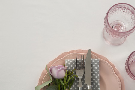 Close-up of beautiful table setting with floral arrangement