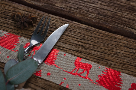 Close-up of fork and butter knife with star anise and decorationの写真素材