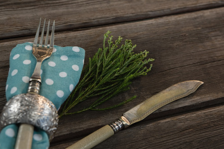 Close-up of place setting equipment on wooden plank