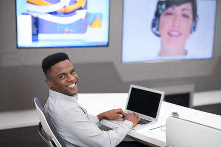 Male executive using laptop while having video call in office