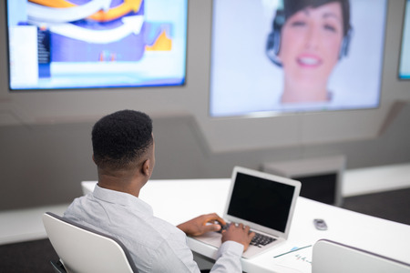 Male executive using laptop while having video call in office